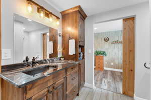 Bathroom featuring vanity and wood finished floors