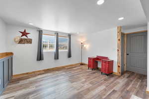 Interior space with wood finished floors and recessed lighting