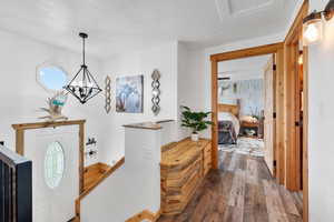 Entrance foyer featuring hardwood / wood-style floors, a chandelier, and a textured ceiling