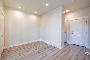 Unfurnished room with light wood-style floors and recessed lighting