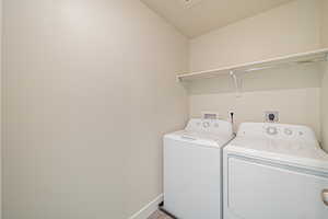 Laundry area featuring washing machine and clothes dryer and wood finished floors