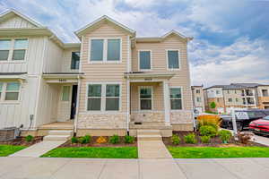 View of front of property featuring stone siding, board and batten siding, and a residential view