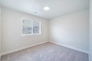 Empty room with carpet flooring and baseboards