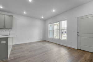 Unfurnished dining area with light wood-style floors and recessed lighting