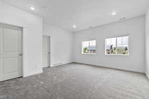 Carpeted spare room featuring recessed lighting