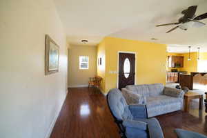 Living area featuring ceiling fan and wood finished floors