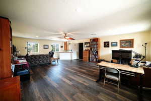 Home office featuring a ceiling fan, dark wood finished floors, a textured ceiling, and recessed lighting