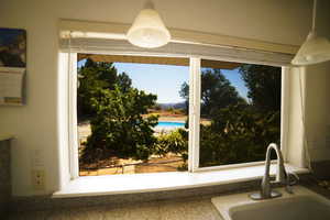 Kitchen view of a sink and decorative light fixtures