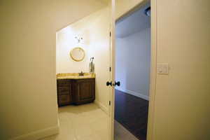 Bathroom with tile patterned floors and vanity