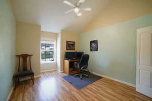 Office with wood finished floors, a ceiling fan, and high vaulted ceiling