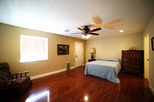 Bedroom with wood finished floors, a textured ceiling, ceiling fan, and recessed lighting