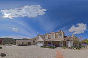 View of front facade with covered porch, driveway, a tile roof, an attached garage, and brick siding