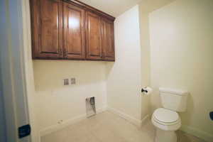 Laundry room with washer hookup and a textured ceiling
