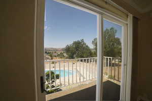 Balcony with view of pool and a mountain view