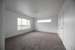 Carpeted empty room with baseboards