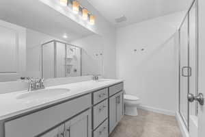 Bathroom with double vanity and a shower stall