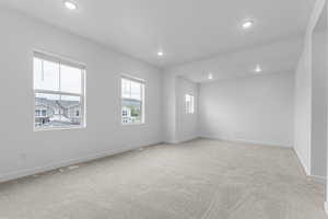 Spare room with light carpet and recessed lighting