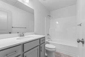 Bathroom with vanity, shower / tub combination, and tile patterned flooring