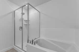 Bathroom with a shower stall and a garden tub