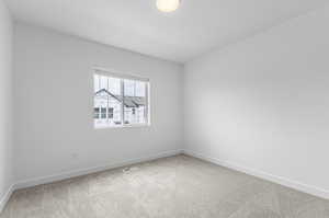 Carpeted empty room with baseboards