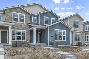 Craftsman-style home featuring stone siding and board and batten siding