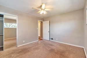 Unfurnished bedroom featuring carpet floors, a closet, and a ceiling fan