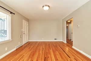 Unfurnished room featuring light wood-style floors and baseboards