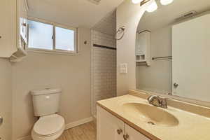 Bathroom featuring vanity and a shower