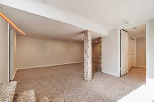 Finished basement with carpet and baseboards