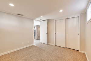 Unfurnished bedroom with light carpet, a closet, and recessed lighting