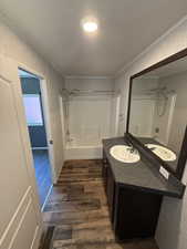 Full bathroom featuring shower / washtub combination, wood finished floors, and vanity
