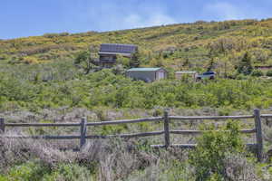 View of yard featuring a storage shed and a view of trees