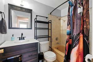 Full bath featuring shower / bath combo and vanity