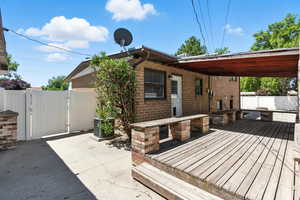Deck with a gate and a patio