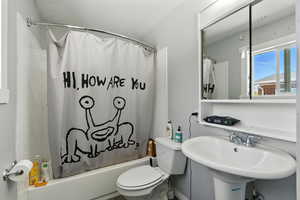 Full bath featuring shower / tub combo and toilet