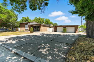 Mid-century modern home featuring brick siding