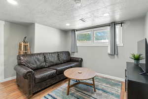 Living area with baseboards and light wood-style flooring