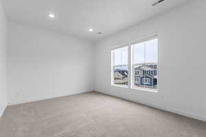 Carpeted spare room featuring baseboards and recessed lighting