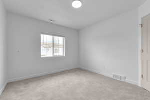 Spare room with carpet and baseboards