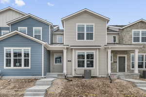 Craftsman house featuring a standing seam roof, a metal roof, and stone siding