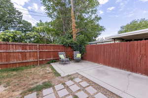 Fenced backyard featuring a patio