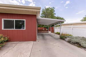 View of home's exterior with an attached carport and concrete driveway