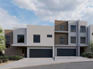 Contemporary home featuring a garage, driveway, and stucco siding