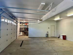 Garage with a garage door opener and storage room