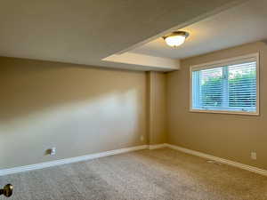 Spacious bedroom with baseboards and a textured ceiling