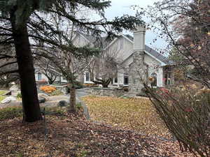 View of side of home featuring a chimney