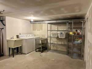 Downstairs laundry area with washer and dryer and a sink
