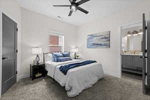 Bedroom with carpet floors, ensuite bath, and a ceiling fan