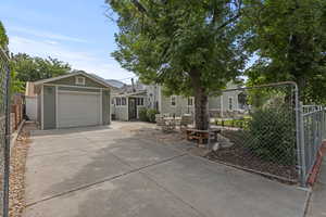View of front facade featuring concrete driveway and a detached garage