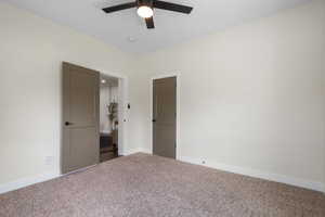 Unfurnished bedroom featuring carpet floors and ceiling fan
